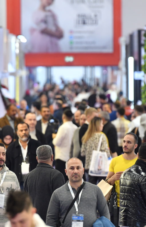 Crowded aisle at CBME Türkiye exhibition, showcasing vibrant visitor engagement.