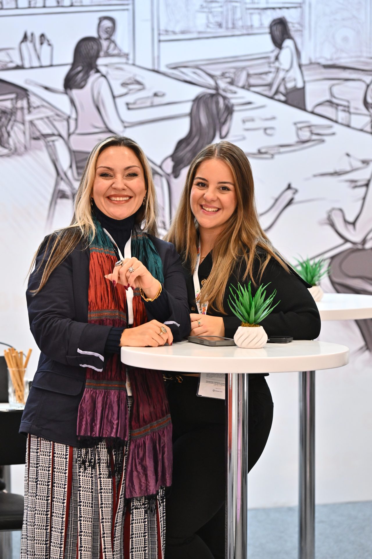 Woman from finance team smiling at CBME Türkiye exhibition with a #HeartOfTrade sign